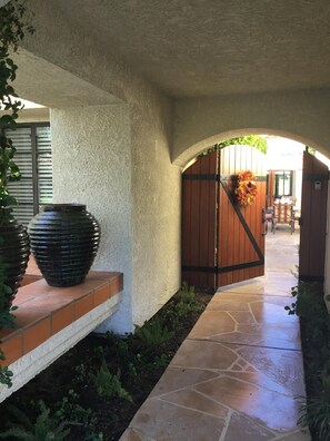 Covered breezeway to private courtyard. 