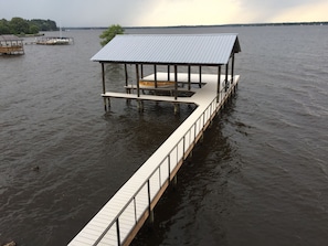 pier has two covered boat slips, lots of sunning area out front