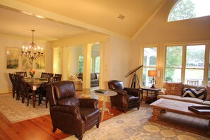 Open concept view of den, dining and sunroom