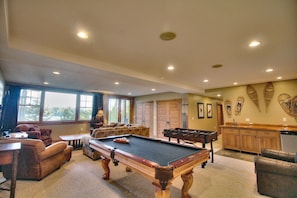 Recreation room and 80" home theater system with beautiful lake views.