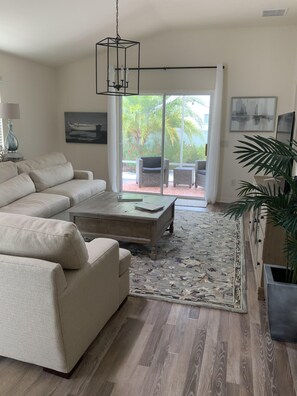 Living Room looking past it from the Dining Room out towards the Lanai