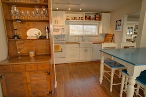 Bar on the left, wonderful modern, sunny kitchen in the background.