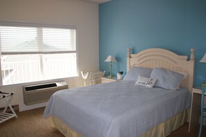 Master bedroom with a Queen bed, desk, dresser, closet, flat screen with cable.