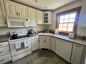Fully equipped kitchen with expandable table or eat outside at sunset.