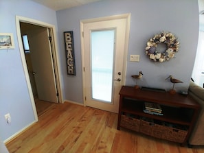 Inside the front door.