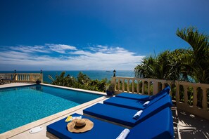 Plenty of lounging options on the pool deck, with an amazing view of St. Barts