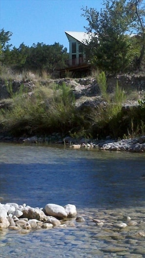 Standing in the river, facing the house