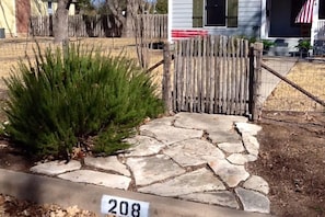 Front Gate at street. Paved walk to cozy front porch -great place to enjoy your morning coffee.