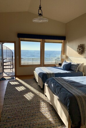 2 queen beds with private deck and direct access to rooftop deck. NW corner.