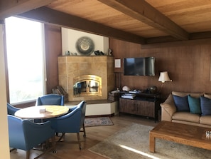 TV rotates for view from all locations. Cabinet filled with board games.