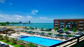 The Chesapeake Lofts condominium complex offers a blend of modern luxury and waterfront charm. Enjoy breathtaking lake views from spacious units, and relax by the stunning outdoor swimming pool, surrounded by lush landscaping and serene coastal vibes. Perfect for leisure and comfort.