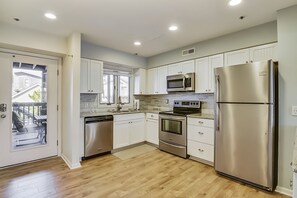 Remodeled, fully stocked kitchen with stainless steel appliances.