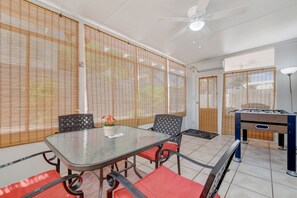 Sunroom with seating area and foosball table