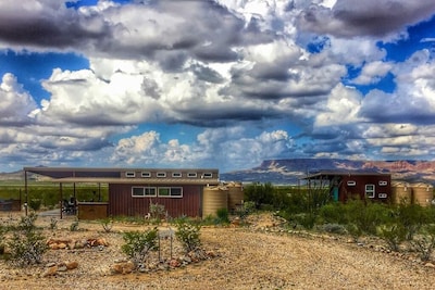 Javelina Hideout and 9 Point Mesa on a cloudy day.  Main home on the left, bunkhouse on the right.