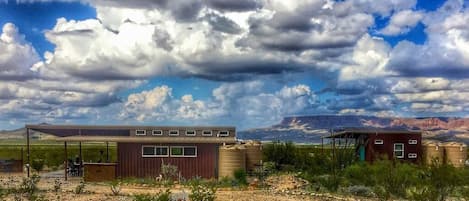 Javelina Hideout and 9 Point Mesa on a cloudy day.  Main home on the left, bunkhouse on the right.