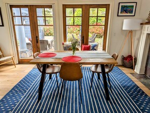 Dining table looking out onto private patio.  Fireplace and TV to right.