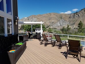 Deck with seating, dining table and pool toys.
