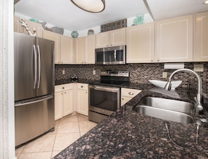 Open concept kitchen with stainless steal appliances.