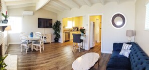 Panoramic of open Living, Dining & Kitchen areas.  