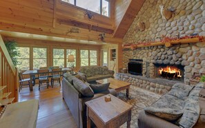 Living Room on Main Floor with TV and Wood Burning Fire Place