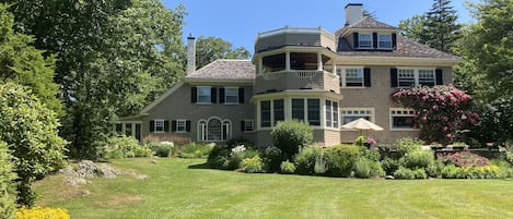 Large flat yard for outdoor games: volleyball, badminton, spikeball, cornhole.