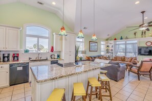 Kitchen with one of two sinks and pop up vent over cook top and double ovens