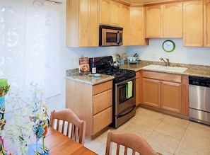 Fully equipped kitchen with green aqua accents.