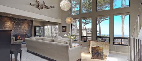 Open living area with view, fireplace and piano