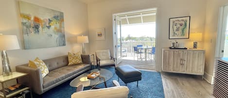 The living room flows out to a large balcony with Gulf of Mexico views.