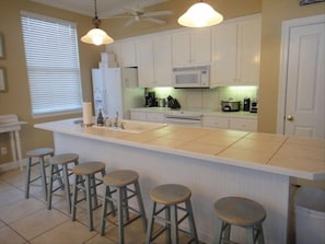 Kitchen is fully stocked with appliances, dishes,cookware