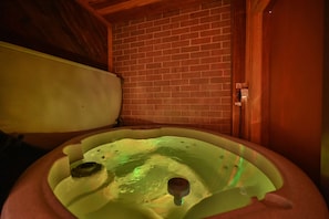 Private Hot tub in Cedar and brick room. 