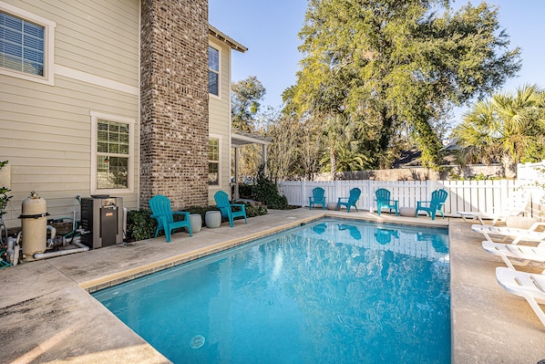 Pool area with plenty of seating and lounge chairs