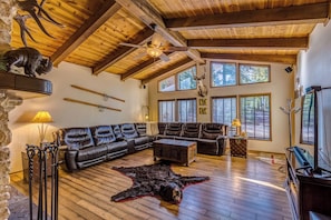 The Living Room sectional w/ leather reclining chairs and views of fireplace.