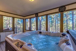 The hottub/spa is located on an enclosed deck, overlooking the forest-seats 6.