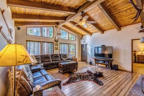 Living Room with leather sectional sofa/ 70" Samsung TV with fireplace views.  