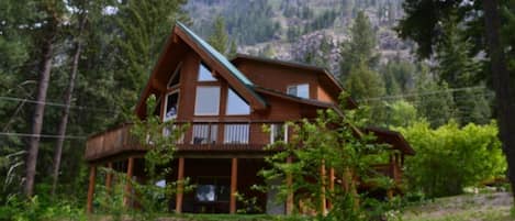 View of cabin with dirty face peak in the background.