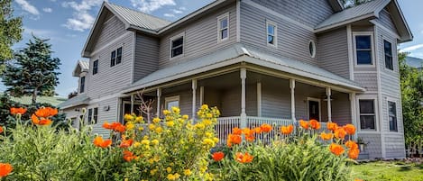 Wrap-around front porch with 4 Adirondack chairs. Large yard space for games!