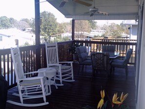 Back deck (covered); 2 ceiling fans, 6 person dining table, gas grill, and rockers