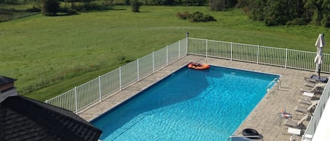 View of the pool and the Hudson Valley in the distance from the master bedroom.