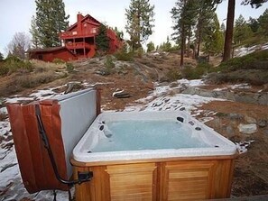 8 person hot tube with forested backyard