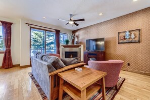 Living Room with gas fireplace, HD Smart TV, sliding glass exit to back patio 