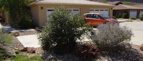 front yard showing two car garage and off street parking