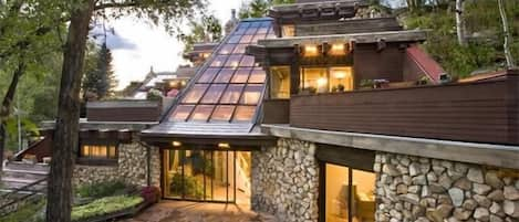 View of house showing sloping glass roof that creates views from all 4 levels