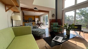 living room is very sunny with two sets of sliding glass doors opening to deck