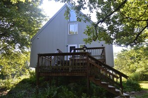 entrance and shady side of the house. Main floor is on second floor, up stairs