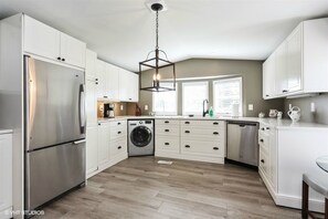 Gourmet Kitchen with dishwasher, gas range, washer/dryer and full size refrigerator