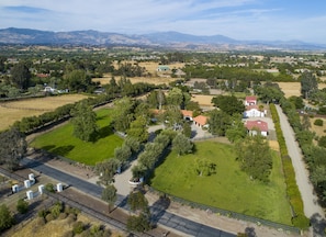 aerial shot: main house, guest house, barn, riding arena & stalls