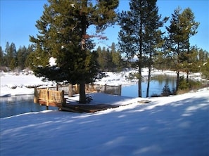 Winter view of log deck overhanging the river