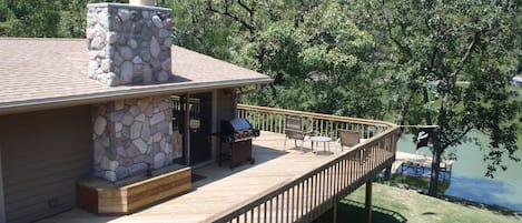 Birdseye view of the huge wrap around deck, front door, pier, and lake front