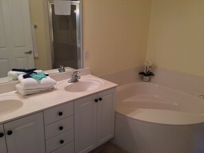 Master bath with garden tub, separate shower, and double vanity.